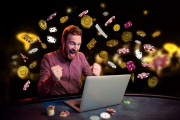 A man celebrating a winning moment on his laptop while gaming symbols float around him, capturing the excitement of 456DB games.
